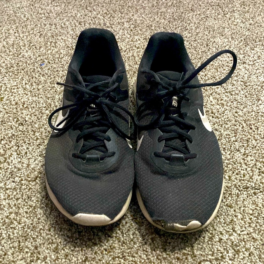 Nike black and white running shoes. Worn, roughed up a little in the front.